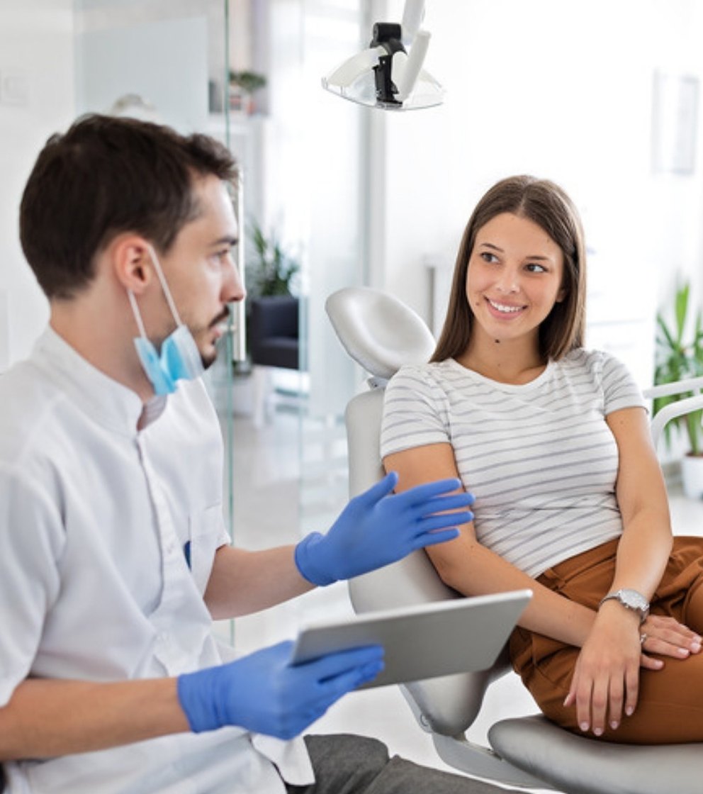 A clinician talking a patient through a treatment plan on a tablet