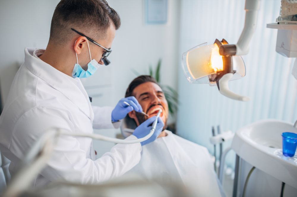 A dentist treating a patient in the dental chair