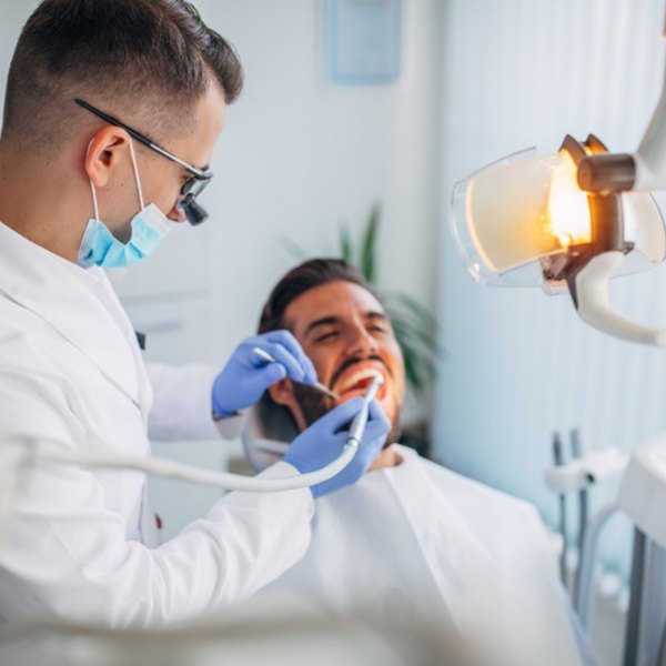 Dentist treating a smiling patient