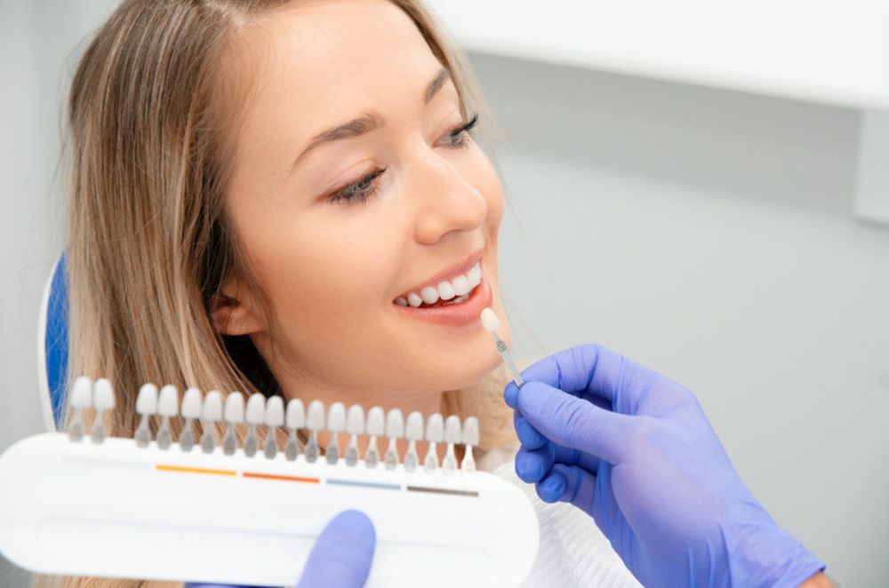 A close-up of a dental check-up with a mouth mirror