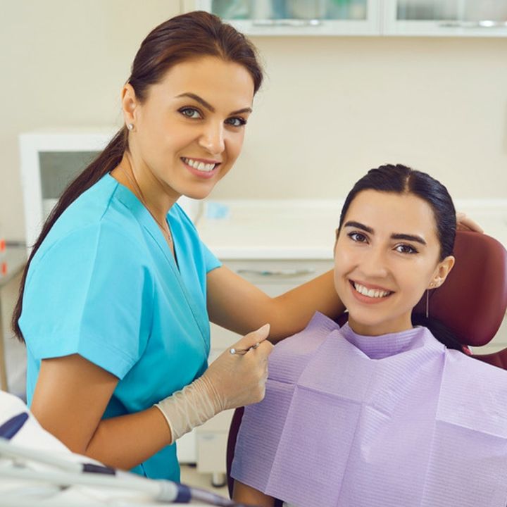 A smiling patient with her dentist