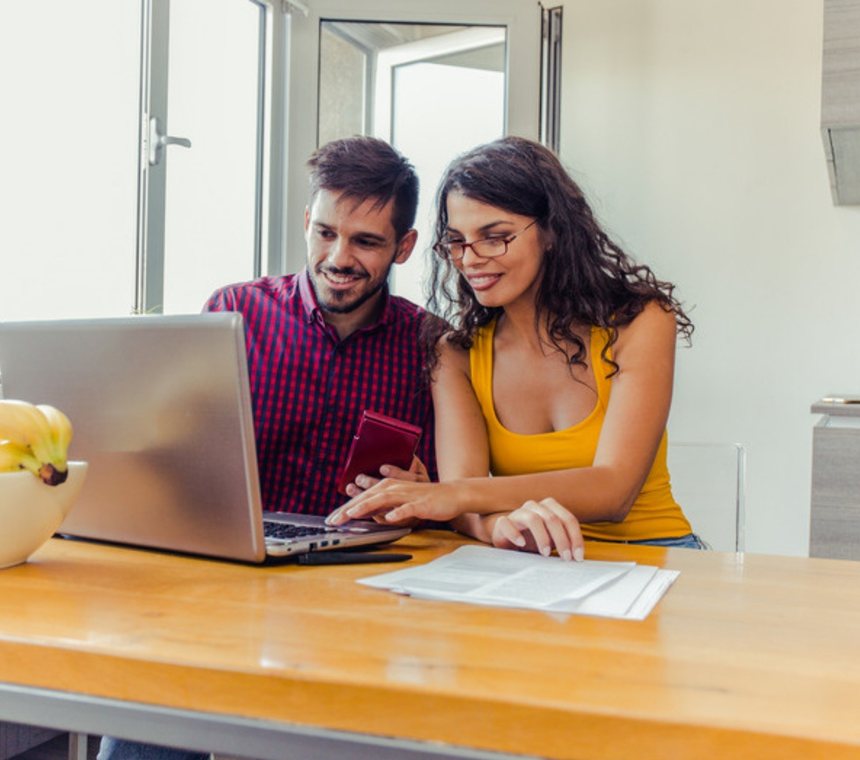 Couple planning treatment costs on a laptop